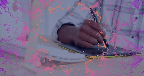 Drawing on graphics tablet with stylus at desk, creative workspace closeup