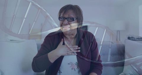 Senior woman reflecting on genetic health with dna double exposure, living room portrait
