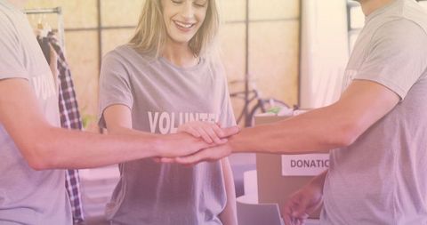 Smiling Volunteers Joining Hands for Teamwork