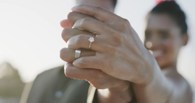 Happy biracial couple holding hands with rings at wedding on beach - Download Free Stock Photos Pikwizard.com