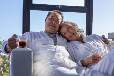 Senior Couple Relaxed in Bathrobes Enjoying Coffee on Terrace