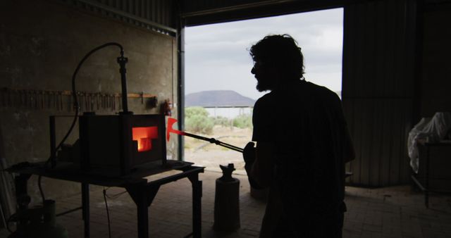 Blacksmith Working at Forge in Dimly Lit Workshop - Download Free Stock Images Pikwizard.com