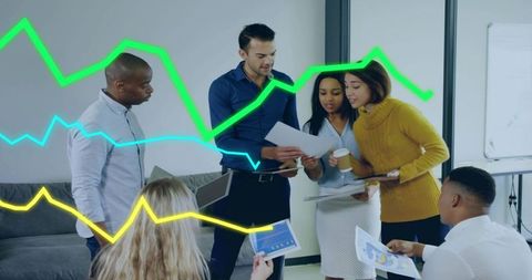 Diverse Business Team Analyzing Sales Trends with Graphs