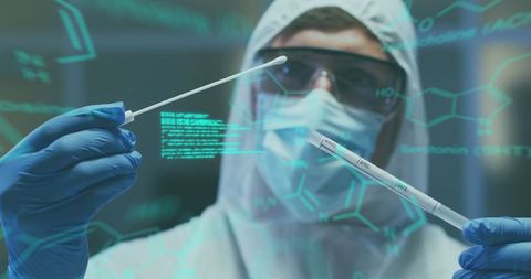 scientist in protective gear analyzing medical data with swabs - Download Free Stock Images Pikwizard.com