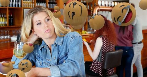 Pensive Woman at Bar with Playful Emojis
