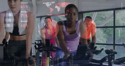 Group Indoor Cycling Class Featuring Focused Woman Leading Spin Workout with Data Overlay