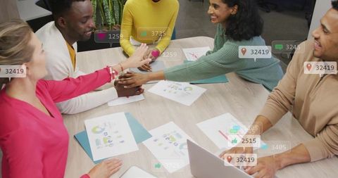 Diverse Team High-Fiving and Collaborating in Modern Office