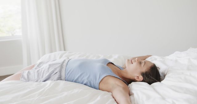 Relaxing Young Woman Lying on Bed in Casual Clothes - Download Free Stock Images Pikwizard.com