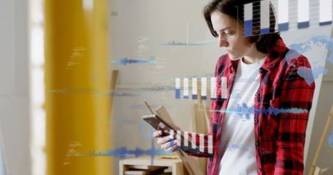 Young woman checking smartphone and tablet with augmented reality analytics overlays