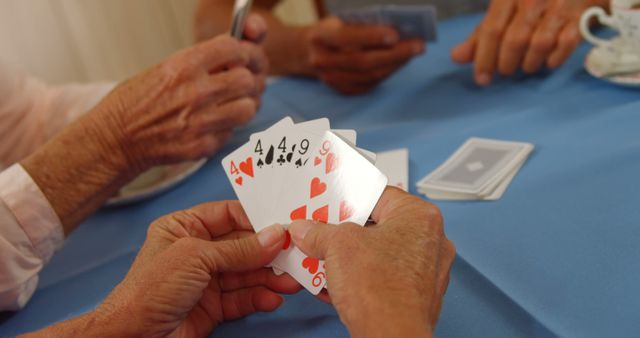 Senior friends playing cards at home 4K