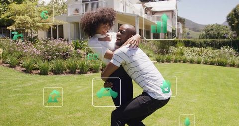 Happy couple embracing on eco-friendly lawn outside modern house