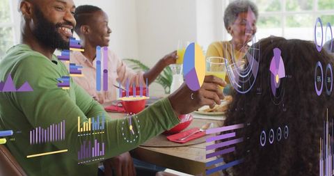 Multigenerational family toasting juice while viewing augmented reality charts and data