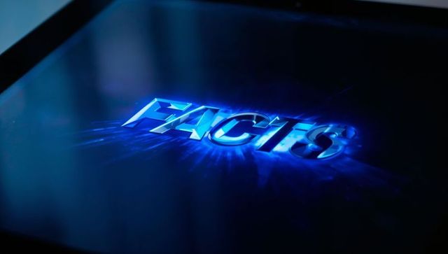 Glowing metallic facts text casting blue neon glow and light streaks across glossy tablet