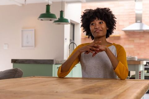 Thoughtful African American Woman in Modern Minimalist Kitchen