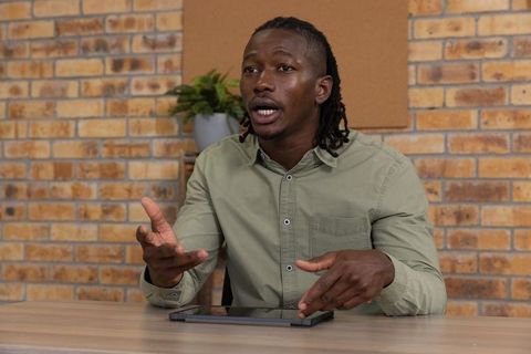 Professional Man Discussing Ideas at Office Desk with Tablet