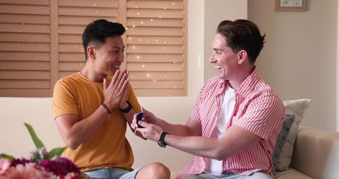Joyful male couple sharing special moment at home