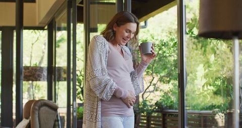 Expecting Mother Enjoying Morning Coffee in Sunny Living Room - Download Free Stock Images Pikwizard.com