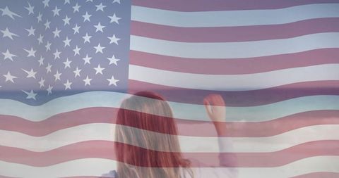 Young girl reaching toward american flag overlay, hopeful patriotism and future freedom