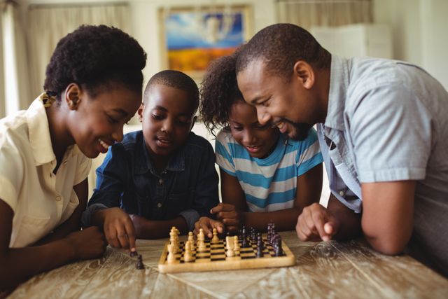 Family gathered around chessboard in living room, engaging in a fun and strategic game. Perfect for illustrating family bonding, educational activities, and indoor leisure time. Ideal for use in articles, advertisements, and blogs about family life, parenting, and educational games.
