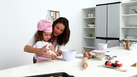 Mother and Daughter Enjoying Baking Together in Modern Kitchen
