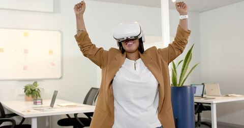 Excited Woman in Office with Virtual Reality Headset