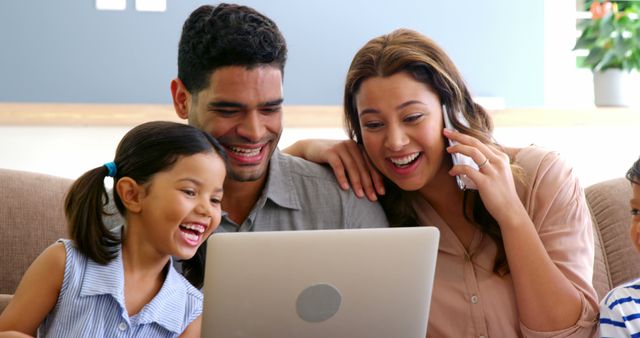 Happy Family Sharing Exciting Moment Over Laptop at Home - Download Free Stock Images Pikwizard.com