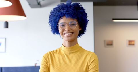 confident businesswoman with blue afro and glasses smiling in office - Download Free Stock Images Pikwizard.com