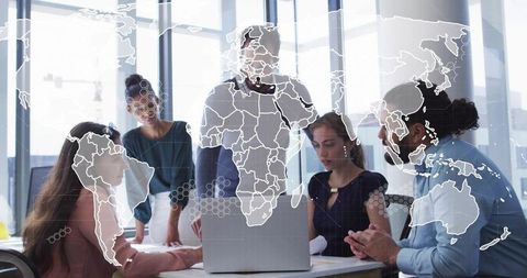 Global strategy team collaborating over laptop with world map overlay in glass office