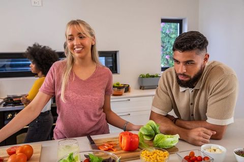 Diverse Friends Preparing Fresh Vegetables in Cozy Kitchen