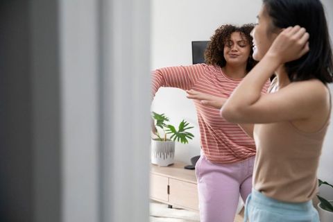 Diverse Friends Dancing with Joy in Modern Living Room