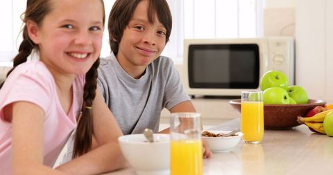 Sibling Breakfast Joy in Modern Kitchen Setting