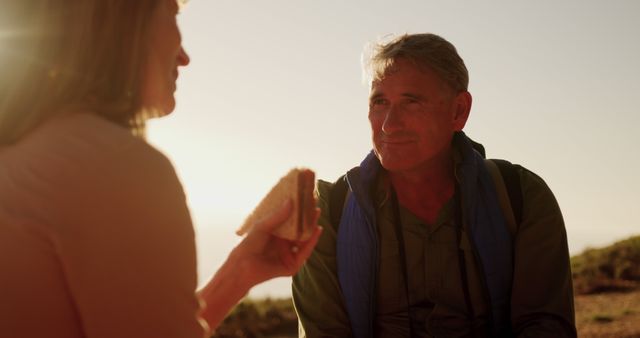 Senior Man and Woman Enjoying Picnic Outdoors at Sunset - Download Free Stock Images Pikwizard.com