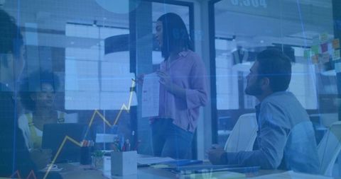 Professional Female Leader Presenting Data in Modern Boardroom