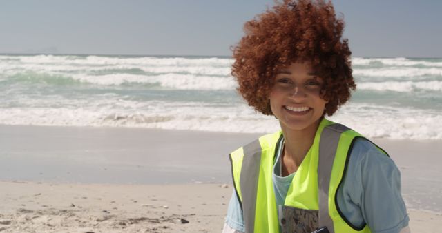 Smiling Volunteer Cleaning Beach with Ocean Waves - Download Free Stock Images Pikwizard.com