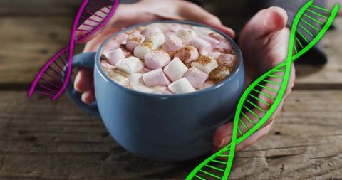 Cradling hands holding blue mug of hot cocoa with marshmallows and colorful dna overlays