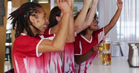 Diverse Friends Celebrating Victory at Sports Bar