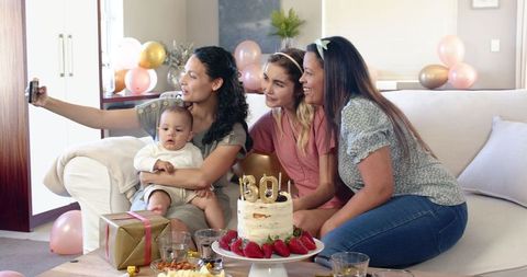 Diverse Women and Baby Celebrating Birthday with Selfie in Living Room