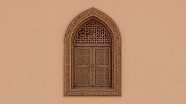 Ornate arched window with carved lattice design on beige facade