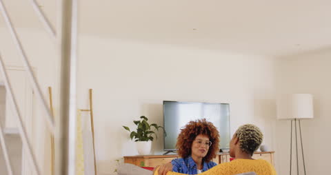 Joyful Diverse Female Couple Relaxing at Home