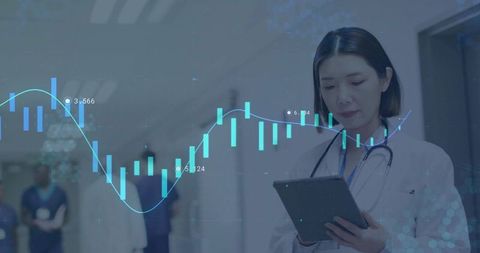 Female doctor reviewing tablet with medical data overlay in hospital corridor