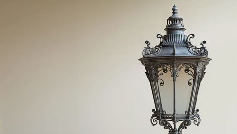 Elegant vintage metal street lamp with ornate design and frosted glass in trieste, italy