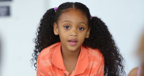 Engaged schoolgirl leading classroom activity