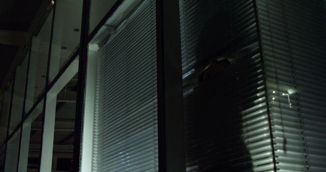 Shadow of Suspicious Person Behind Office Blinds at Night - Download Free Stock Images Pikwizard.com