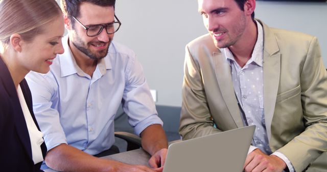 Business Team Collaborating on Project with Laptop, Engaging Office Discussion - Download Free Stock Images Pikwizard.com