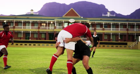 Rugby Players Intensely Competing on Field