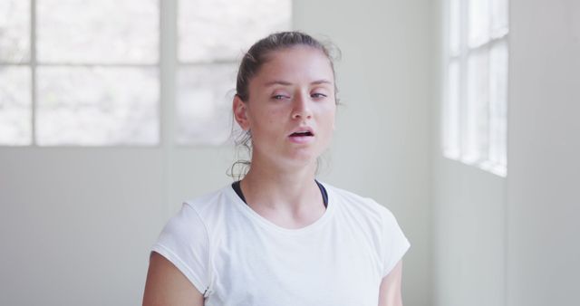 Tired Female Athlete Resting in Sunlit Room - Download Free Stock Images Pikwizard.com