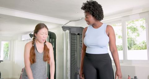 Female Fitness Instructor Guiding Gym Training Session with Kettlebell