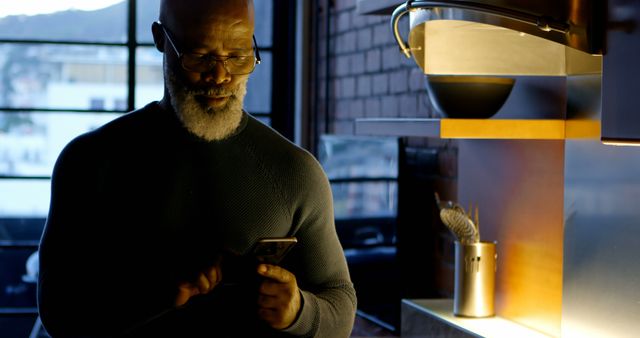 Mature Man Using Smartphone in Modern Kitchen at Evening - Download Free Stock Images Pikwizard.com