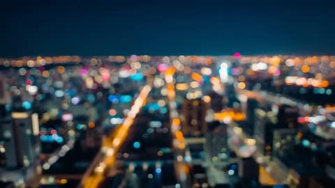 Captivating Drone Pass Downtown with Bokeh City Lights