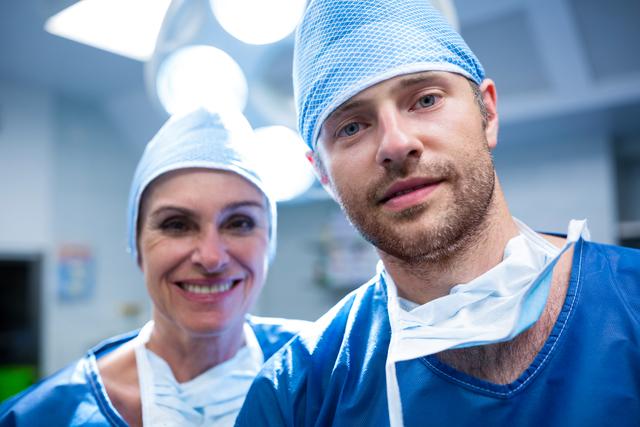 Portrait of surgeons standing in operation room at hospital